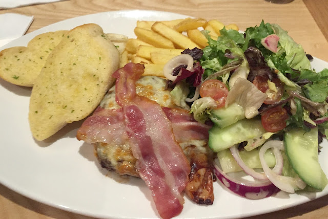 Smothered Chicken main meal with chips, salad and garlic bread