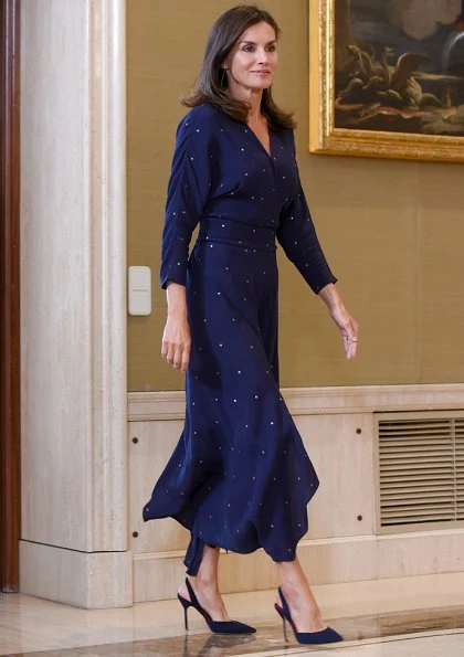 Queen Letizia wore a new asymmetric midi dress by Maje. We saw the same dress on Argentina's First Lady Juliana Awada