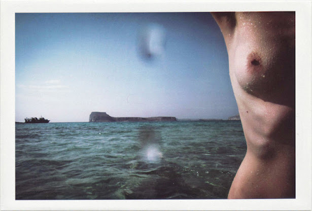 dirty photos - on the island of - photo of female breast at the beach and gramvousa in the background