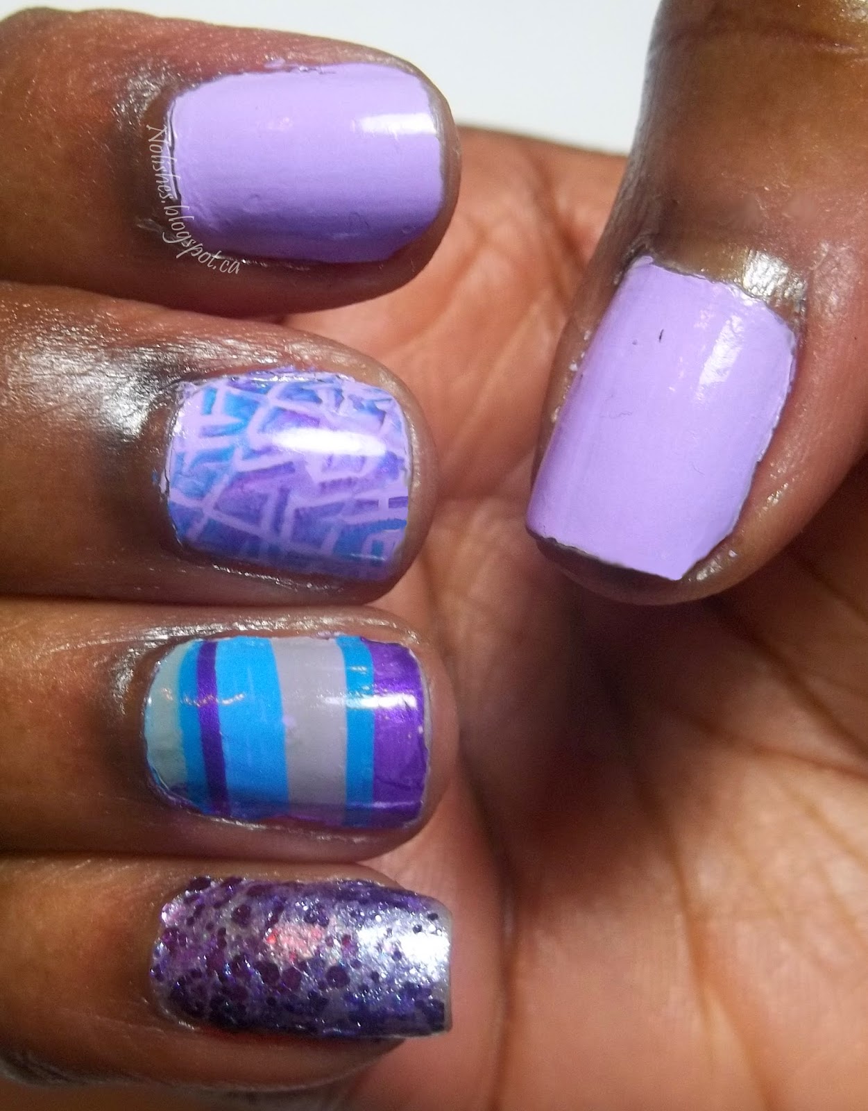 Purple Water Marble and Stamping Mani. Accent colours are teal, bright blue and grey. The water marble has bands of all 4 colours, and is only on the ring finger. The middle finger is the only one stamped with a geometric design, with a multi-colour polish application. The pinky is covered in purple glitter, and the thumb and index fingers are solid light purple.