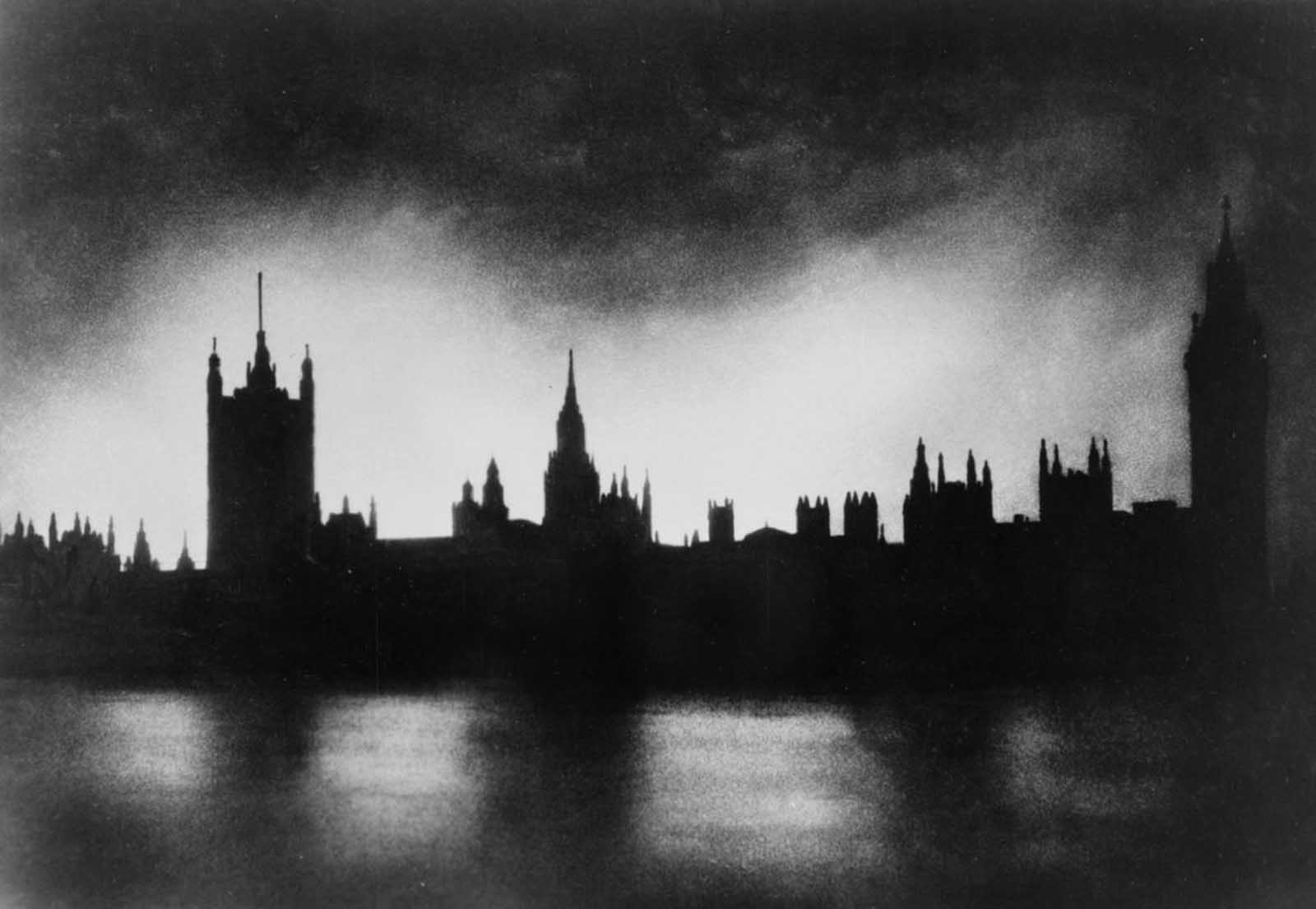 The Palace of Westminster in London, silhouetted against light from fires caused by bombings.