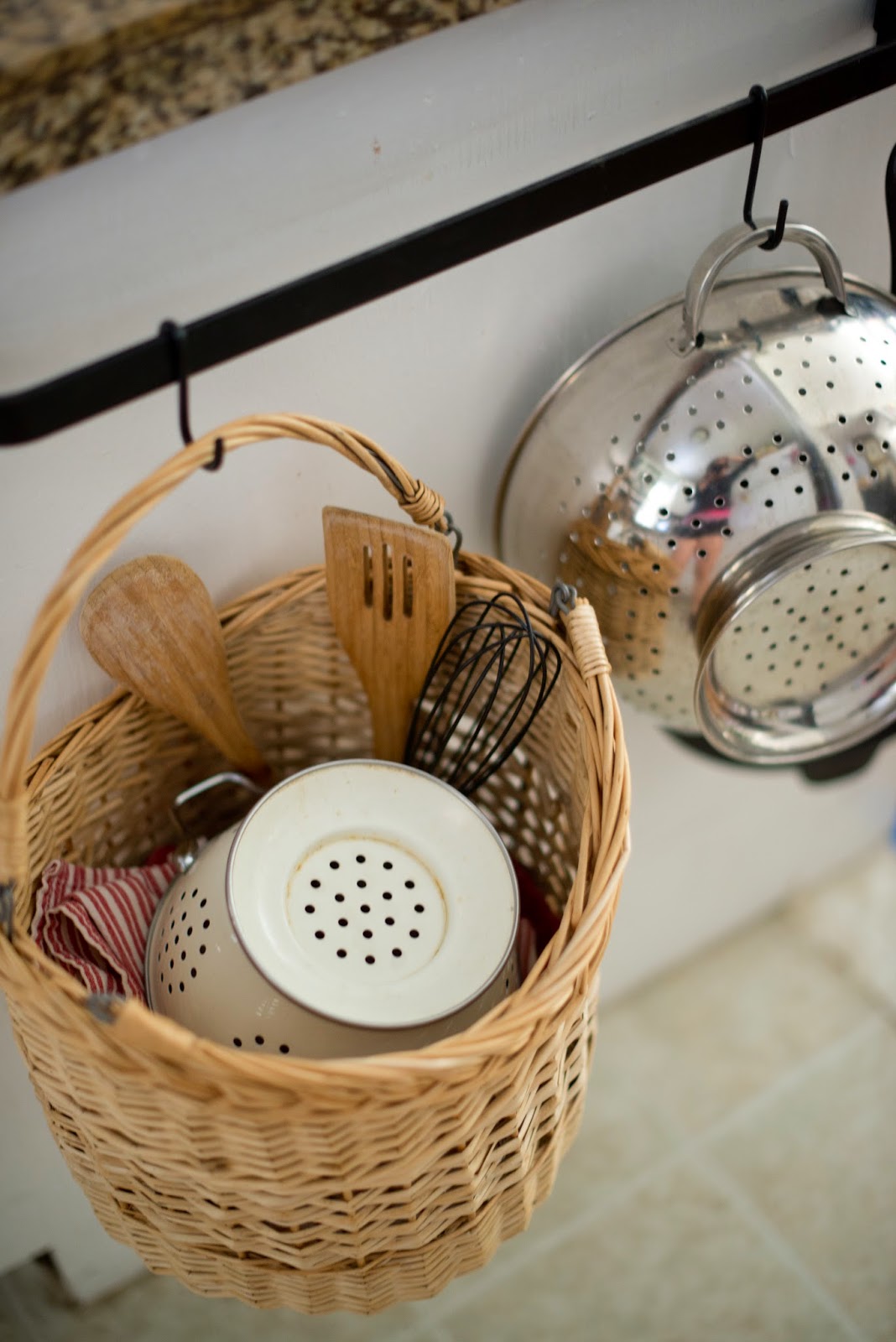 Use a towel bar to hold kitchen supplies. A cute way to organize the kitchen.