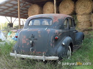 Primered or faded paint covers the 1939 Chevy. It wears well after more than seven decades.