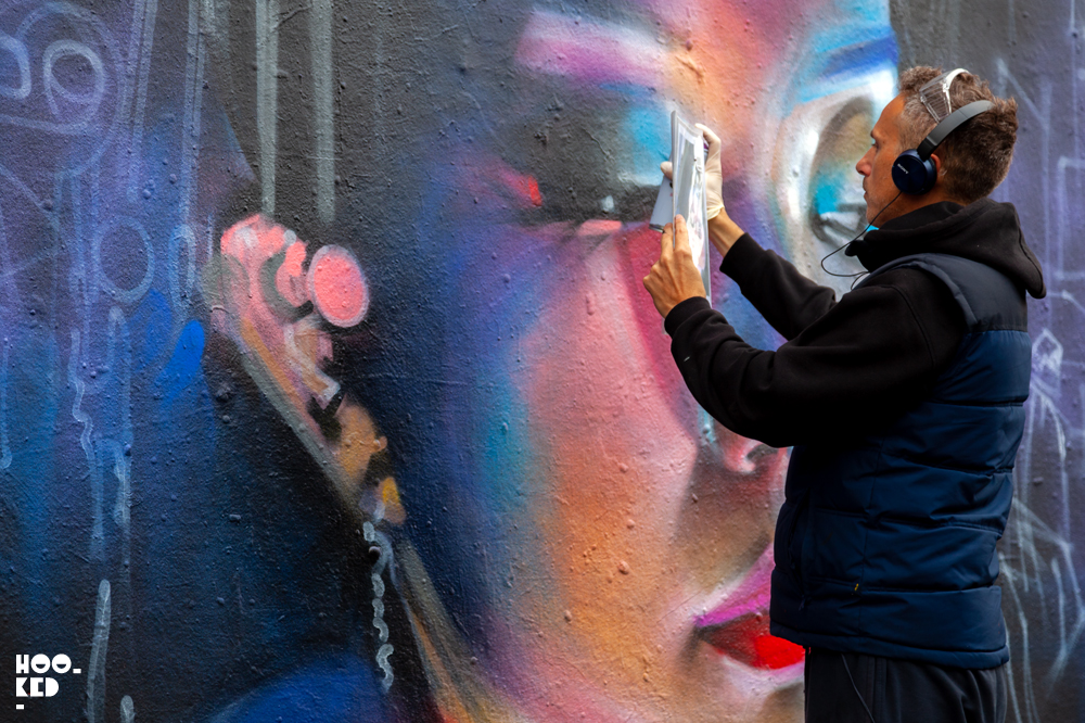 Street artist dan kitcheners at work on his new ghost cities mural Street artist dan kitcheners at work on his new ghost cities mural