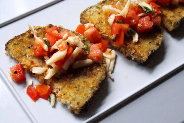Skinny Bruschetta that uses crispy baked eggplant slices instead of toasted bread.