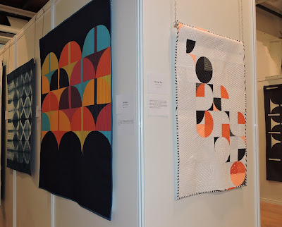 Luna Lovequilts - My quilt Orange Pop and Bridges by Anne Sullivan hanging at Patchwork Sitges 2018
