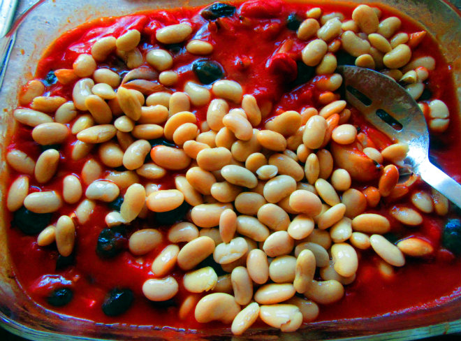 Cod and tomato bake by Laka kuharica: stir in chopped tomatoes, tomato puree and cannellini beans.