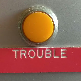 a yellow light labeled trouble