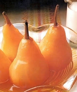 Pears poached in cider in a pressure cooker served upright in a glass dish.
