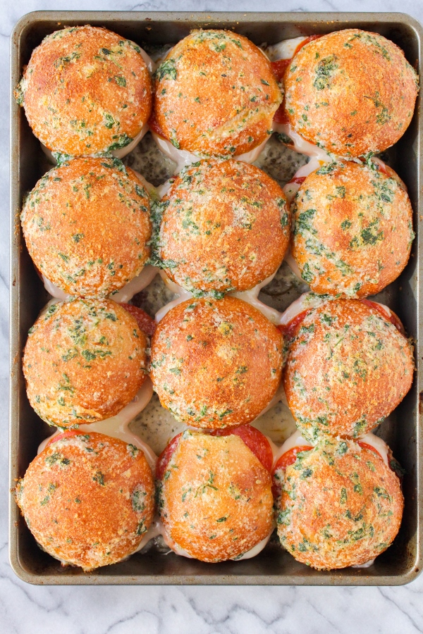Easy, cheesy and over the top delicious, these Baked Pepperoni Pizza Sliders will be the hit of your next get together or party!
