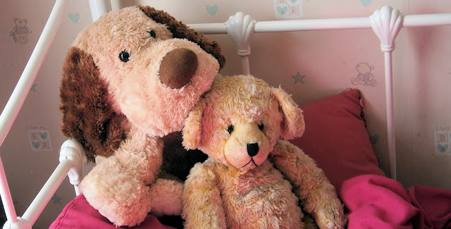 Teddy bear on girls bed