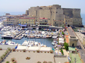 Castel dell'Ovo with the yachts and harbourside restaurants of Borgo Marinari in the foreground