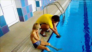swimming teacher puts cap on kid swimmer funny
