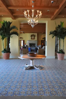 San Tropez cement tile pattern, used in this resort's lobby, features a color pallet that includes blue, mustard, white and gray.