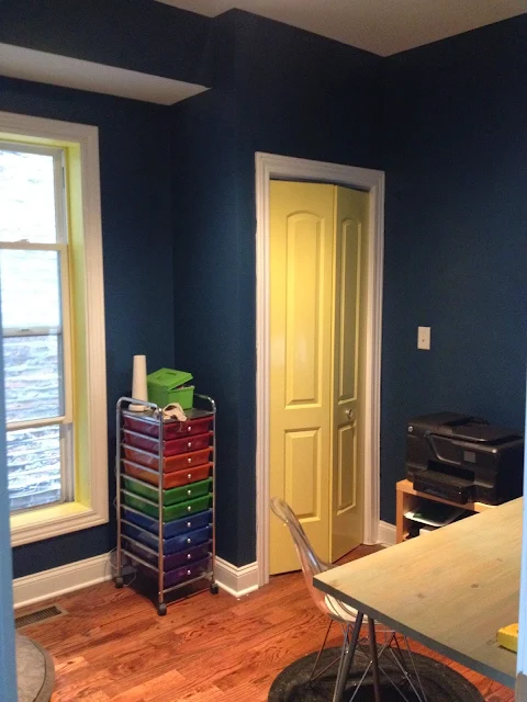 office painted after with a moody navy blue and canary yellow