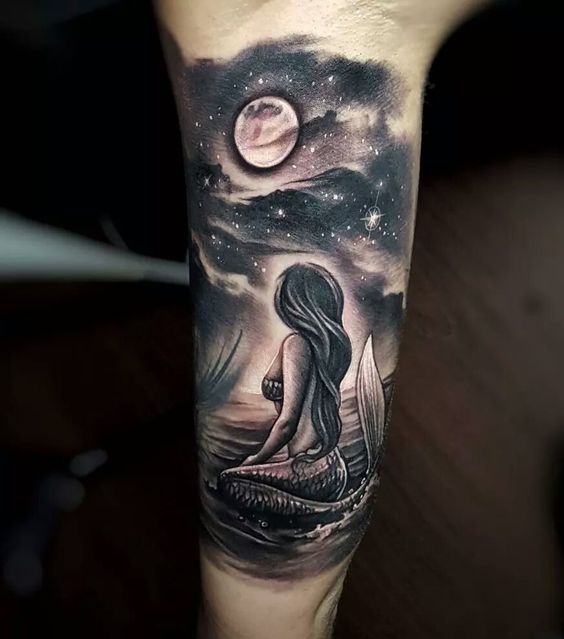 Mermaid tattoos siting and watching moon and stars