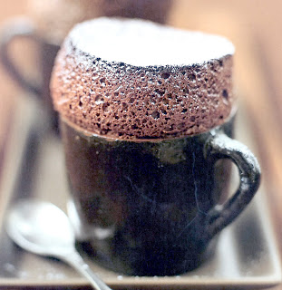 Classic chocolate soufflé prepared and served in a mug.