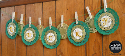 SRM Stickers Blog - St. Patrick's Day Doily Banner by Christine - #banner #stpatrickesday #doilies #golddoilies #punchedpieces #twine #DIY