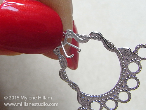 Triangle jump ring hooked through loop in silver filigree chandelier earring fitting