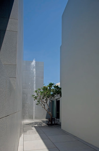 A spectacular two-story-high fountain is located in a deep canyon like courtyard