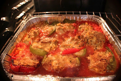 these are a pan of Italian Stuffed peppers with tomato sauce meat and rice