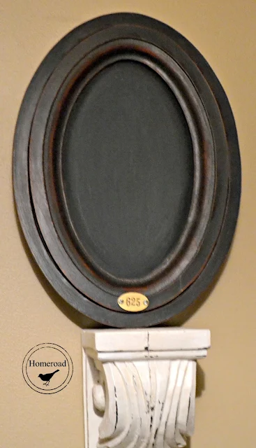 oval chalkboard with metal tag and corbel