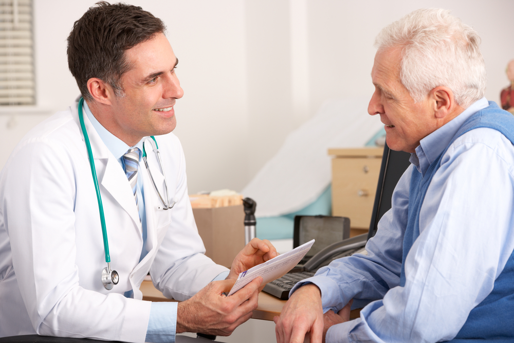 Doctor consults with older male patient