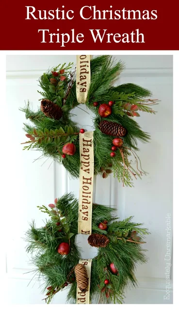 Two green holiday wreaths on a white door