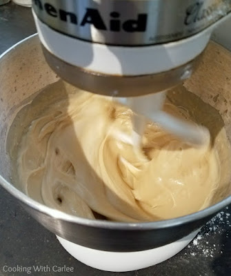 mixer bowl with paddle beating frosting