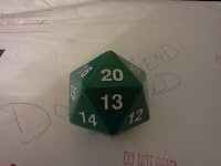 A green, fist-sized d20 used for tabletop role playing games