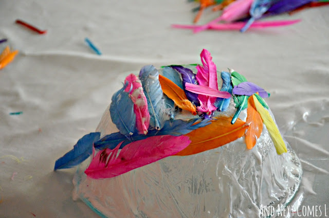 A close up of a fine motor craft with feathers for kids