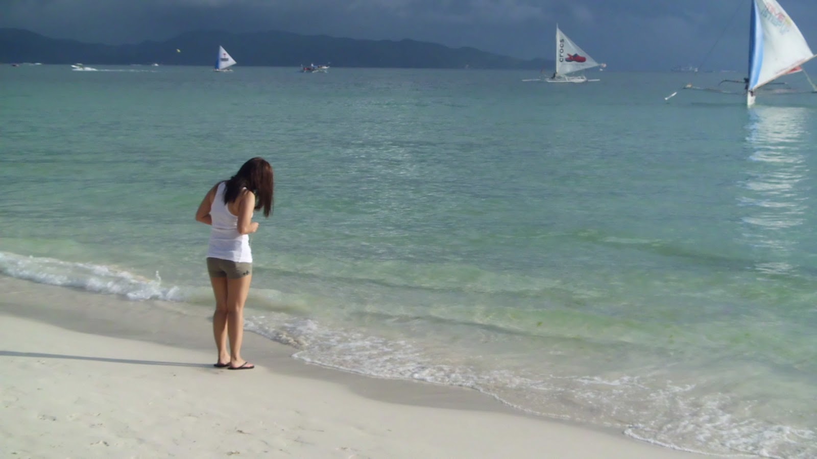 This girl was taking a photo of her feet in the sand. Typical of everybody, really.