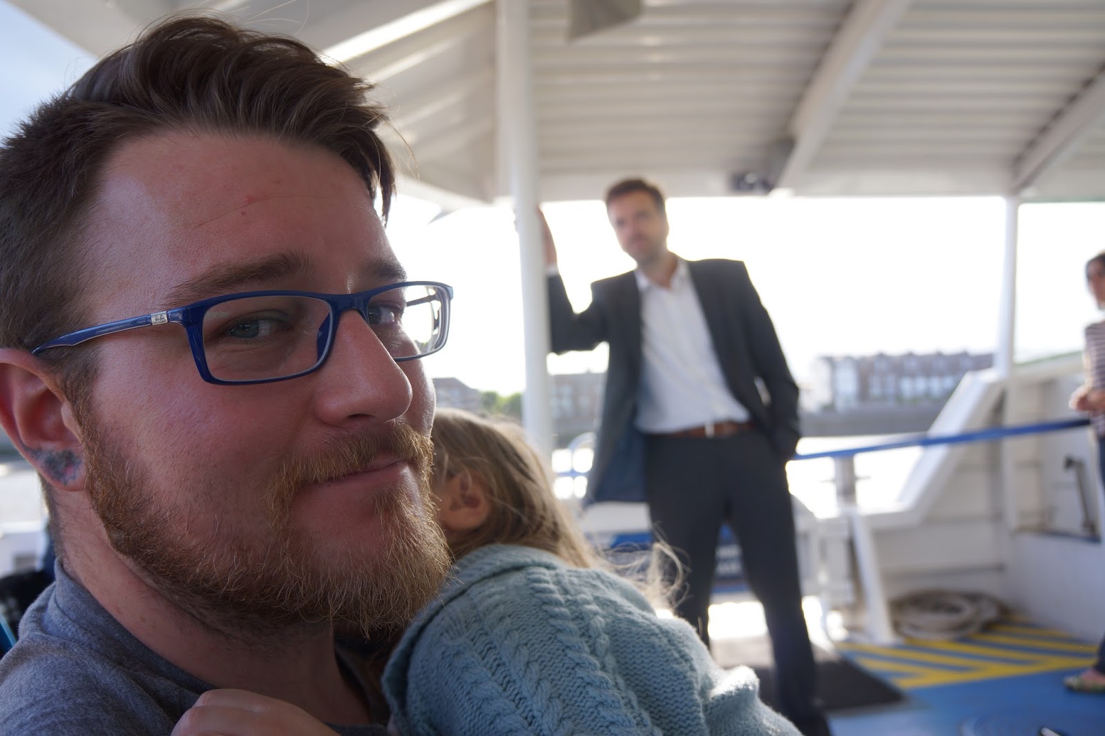 father and daughter riding on the mbna thames clipper boat service