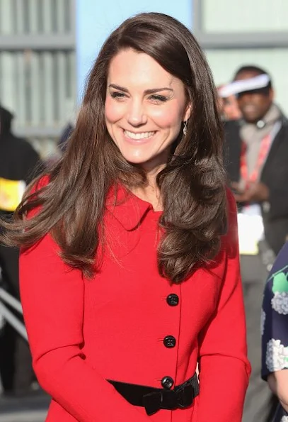 Kate Middleton wore Luisa Spagnoli red suit, Gianvito Rossi black suede pumps, Mulberry suede clutch, Mappin & Webb earrings. Place2Be