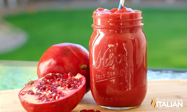 strawberry pomegranate smoothie in mason jar glass