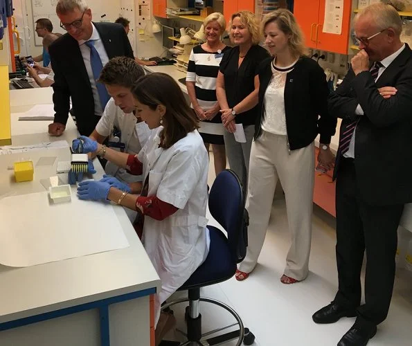 Crown Princess Mary wore a red dress from 'Peper' collection of ba&sh and Gianvito Rossi shoes for visit National Center for Immune Therapy