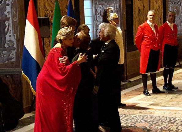 Queen Maxima at gala dinner wore a red gown by Valentino. Queen Maxima wear diamond tiara. diamond earrings. Mrs Laura Mattarella