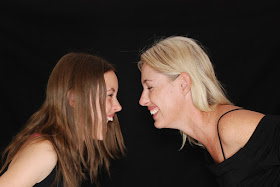 Mom and daughter facing each other, laughing, happy