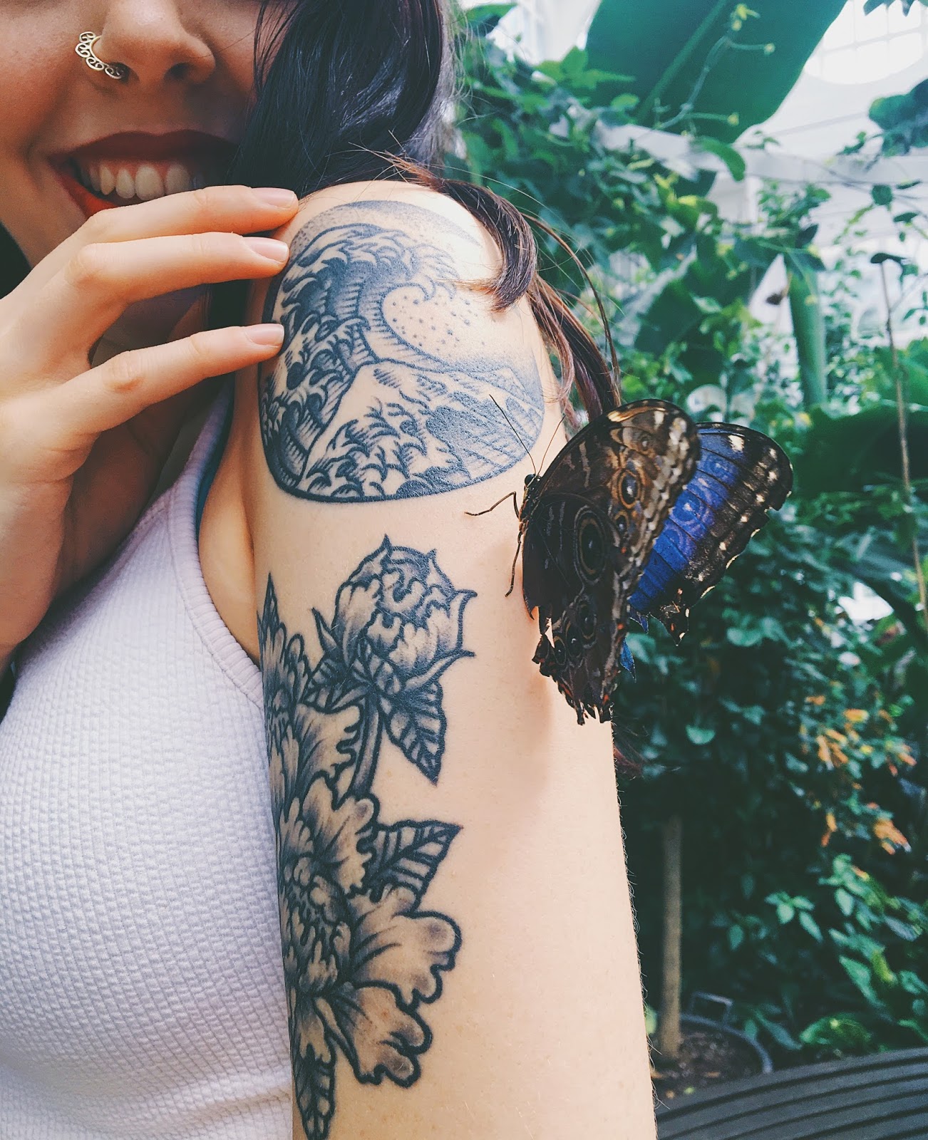 blue butterfly on arm