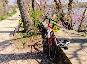 Bicycles leaning on stone wall and river 