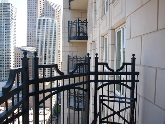 Limestone facade and iron balcony at Waldorf Chicago by Hello Lovely Studio