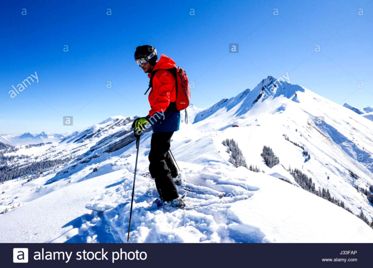 Skier standing on a mountain top free ride skiing area Haldigrat Skier standing on a mountain top free ride skiing area Haldigrat