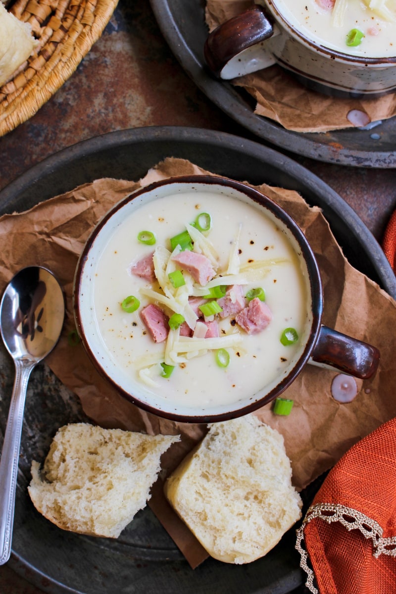 Instant Pot Cheesy Cauliflower and Ham Soup is creamy and delicious made with a head of cauliflower, ham, and white cheddar cheese.  It comes together in under a half an hour and is a great way to use up leftover ham! #soup #leftoverham #cauliflower