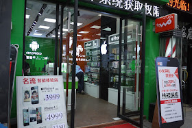 Sign for iPhones and an iPhone accessory display case at the Android store
