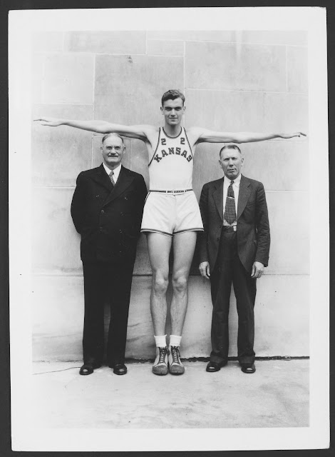 Dr. James Naismith (left), W. Harry Kersenbrock (middle), Coach Forrest C. “Phog” Allen (right) 7 ft tall Harry was recruited to KU but drowned in a canoe accident before the season started. Baskets and Ladders. marchmatron.com Dr. James Naismith (left), W. Harry Kersenbrock (middle), Coach Forrest C. “Phog” Allen (right) 7 ft tall Harry was recruited to KU but drowned in a canoe accident before the season started. Baskets and Ladders. marchmatron.com