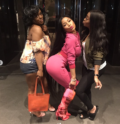 Nicki Minaj poses in pink outfit with friends in London
