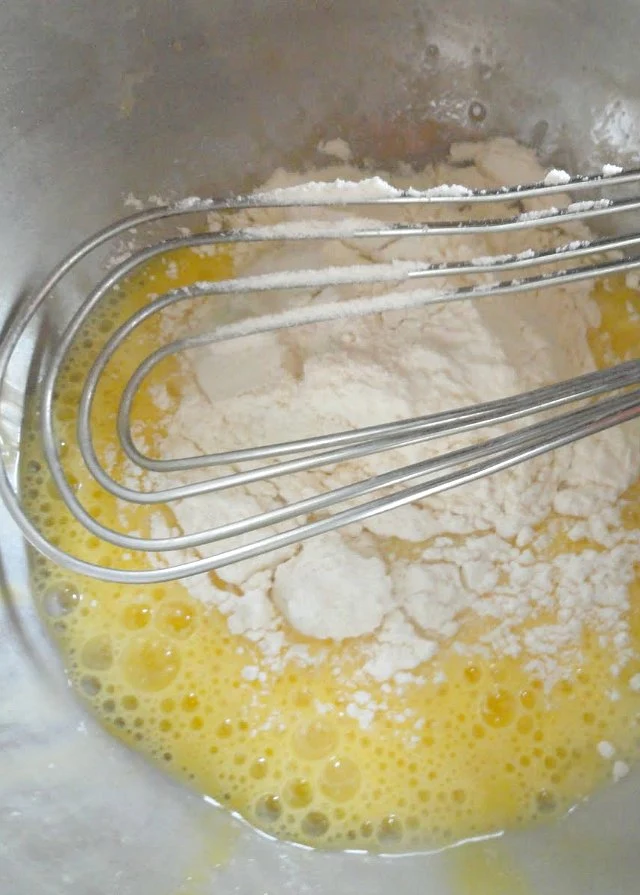 German Pancakes whisk eggs, and add flour. Mix until combined from Serena Bakes Simply From Scratch.