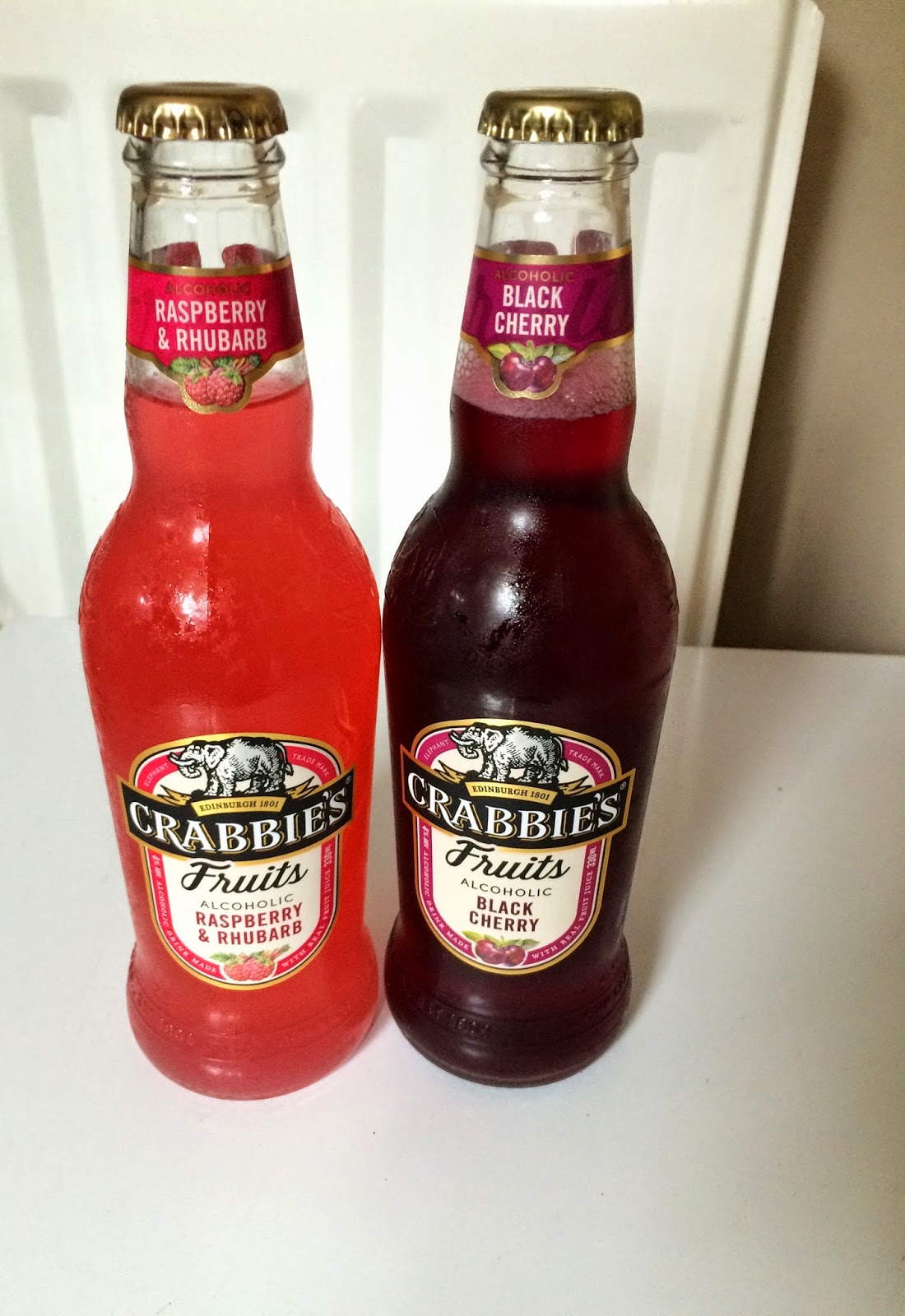 two bottles of Crabbies fruit drinks 
