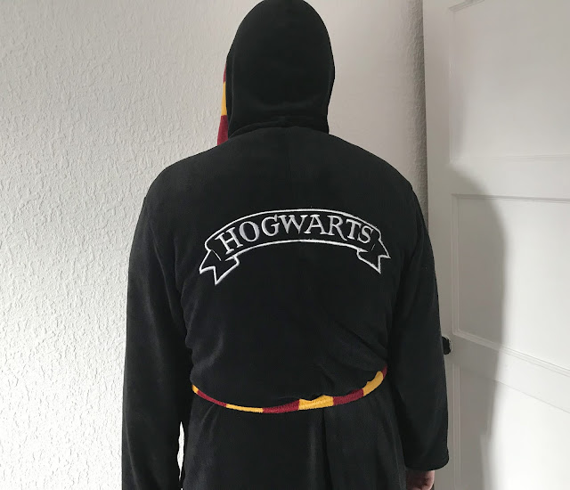 Black mans dressing gown with Hogwarts on back 