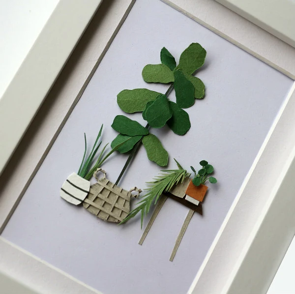 framed, cut paper house plant scene with table and potted plants